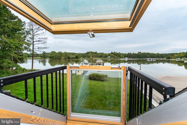 balcony featuring a dock and a water view