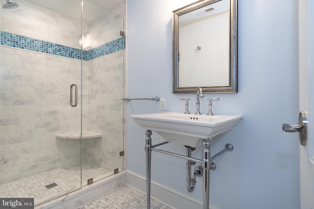 bathroom with a stall shower and visible vents