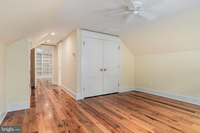 bonus room with lofted ceiling, recessed lighting, hardwood / wood-style floors, a ceiling fan, and baseboards