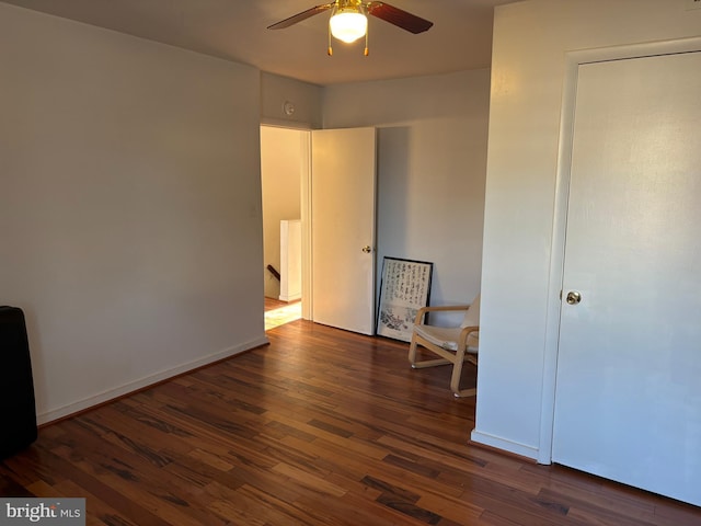 unfurnished room featuring dark hardwood / wood-style floors and ceiling fan