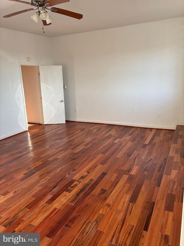 unfurnished room with ceiling fan and dark hardwood / wood-style flooring