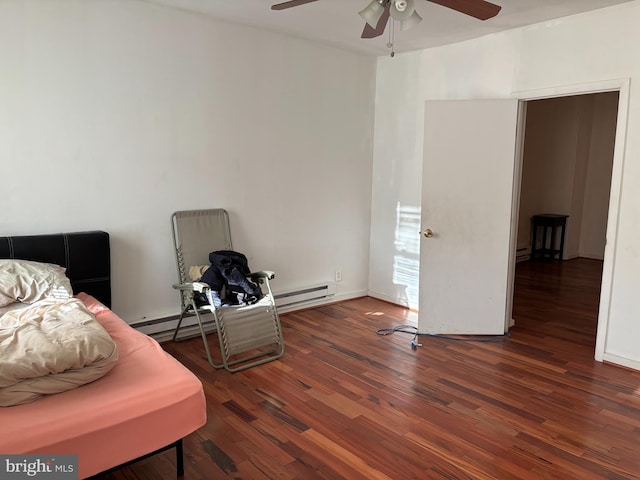 bedroom with dark hardwood / wood-style flooring, a baseboard radiator, and ceiling fan