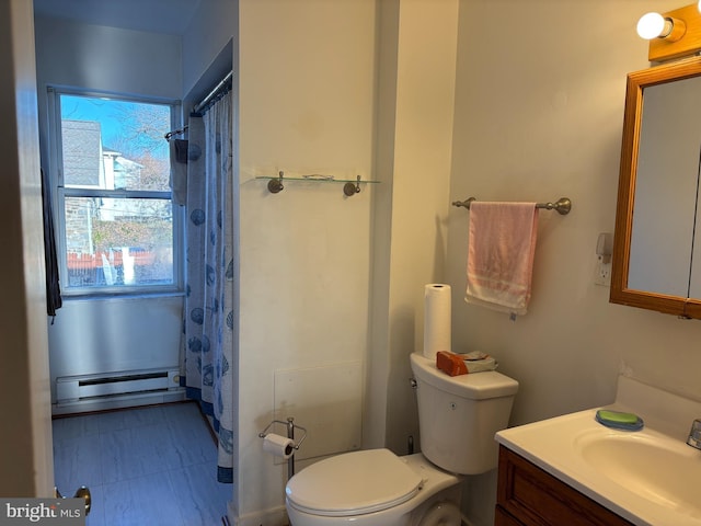 bathroom featuring baseboard heating, vanity, and toilet