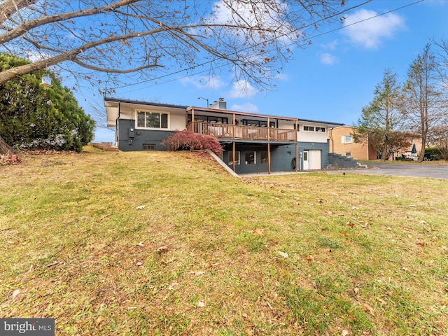 back of house featuring a yard and a wooden deck