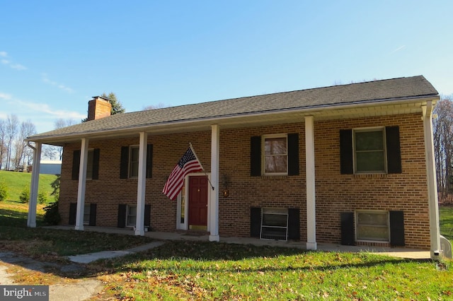 raised ranch featuring a front lawn