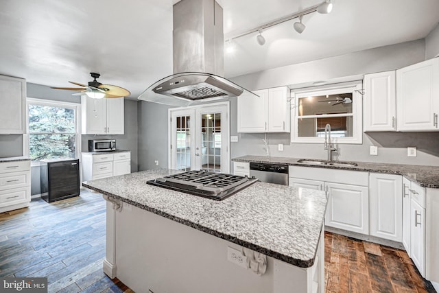 kitchen featuring white cabinets, sink, dark hardwood / wood-style floors, appliances with stainless steel finishes, and island range hood