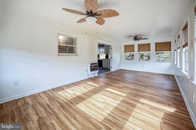 interior space featuring heating unit and ceiling fan