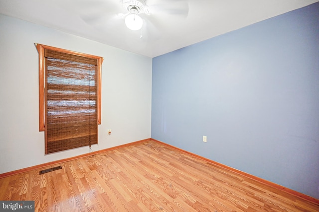 empty room with ceiling fan and light wood-type flooring