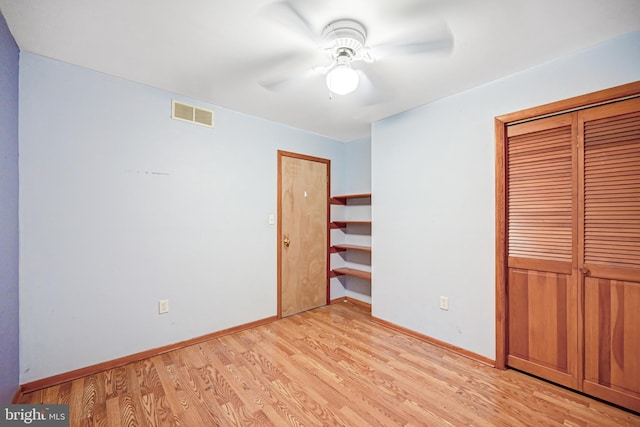 unfurnished bedroom with ceiling fan, a closet, and light wood-type flooring