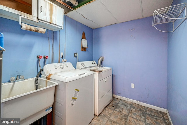 laundry room with cabinets, independent washer and dryer, and sink