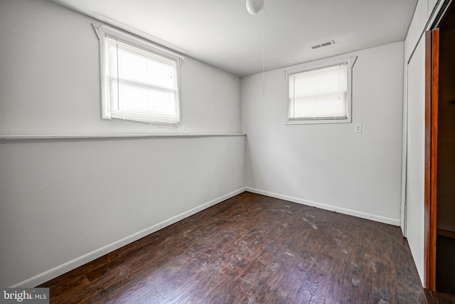 interior space featuring dark hardwood / wood-style floors and multiple windows