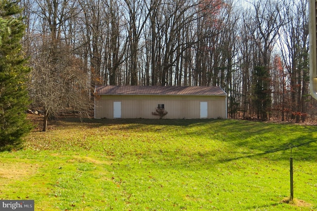 view of outdoor structure featuring a lawn