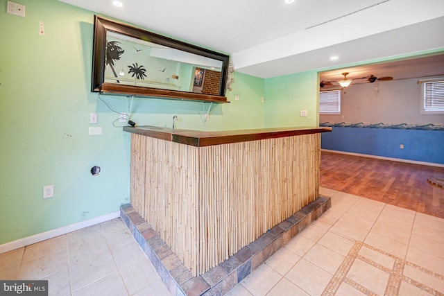 bar featuring hardwood / wood-style flooring and ceiling fan