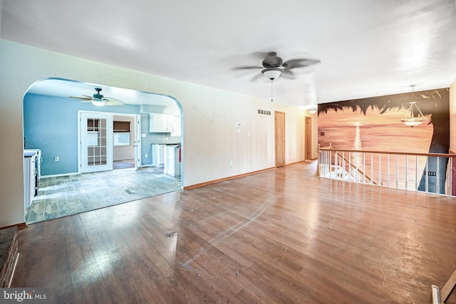 unfurnished living room featuring ceiling fan and hardwood / wood-style floors