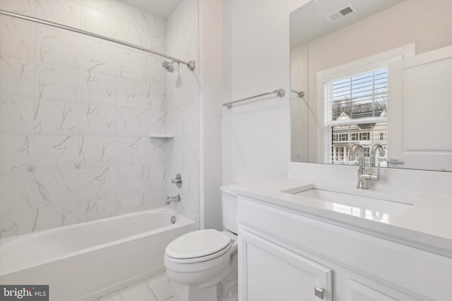 full bathroom with tiled shower / bath combo, vanity, tile patterned floors, and toilet