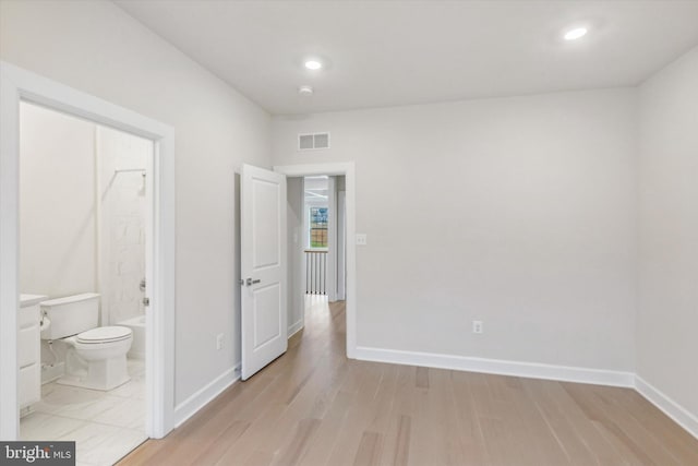 interior space featuring ensuite bathroom and light hardwood / wood-style flooring