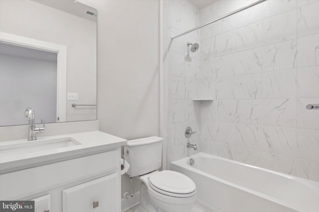 full bathroom with tiled shower / bath, vanity, and toilet