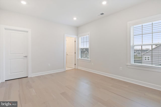 unfurnished room with light hardwood / wood-style flooring