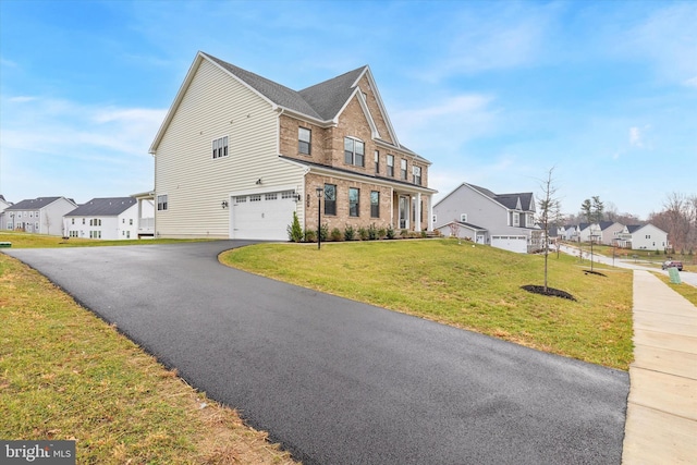 view of front facade with a front yard and a garage