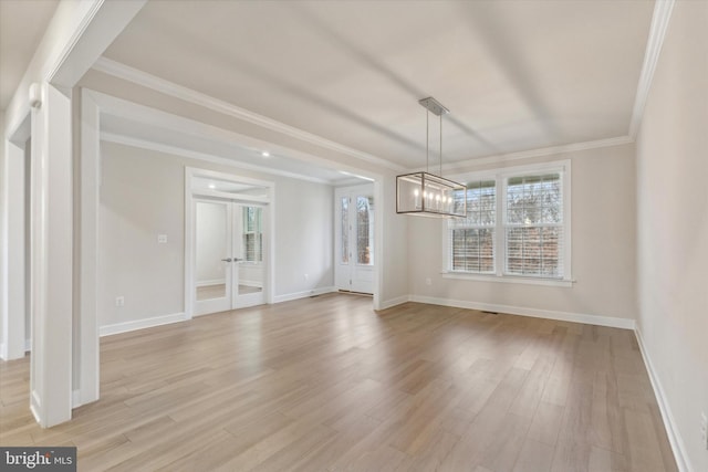 interior space with crown molding, plenty of natural light, a chandelier, and light hardwood / wood-style flooring