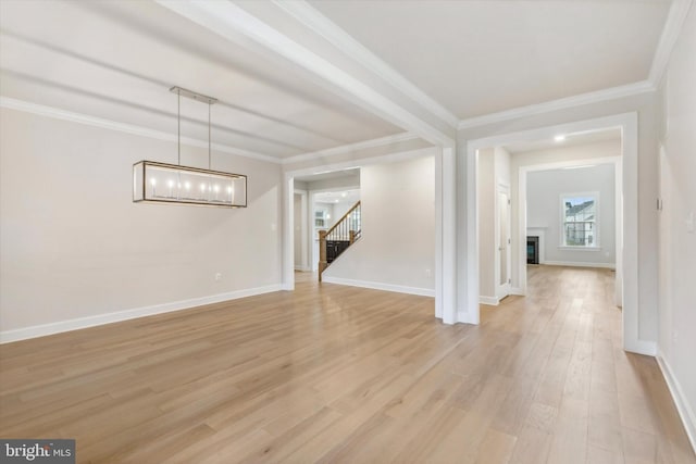 interior space with ornamental molding and light hardwood / wood-style flooring