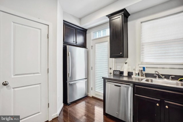 kitchen with dark hardwood / wood-style flooring, sink, and stainless steel appliances