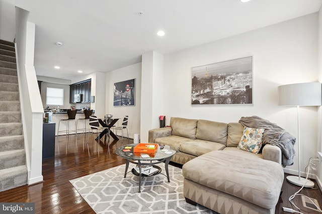 living room with dark hardwood / wood-style flooring