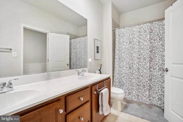 bathroom with tile patterned flooring, vanity, and toilet