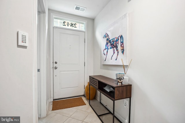 doorway with light tile patterned floors