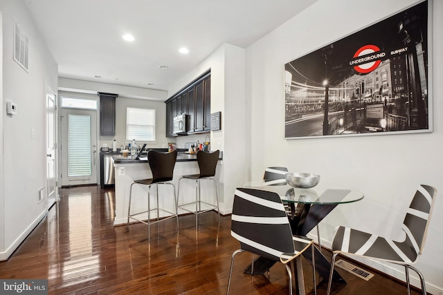 dining space featuring dark hardwood / wood-style flooring