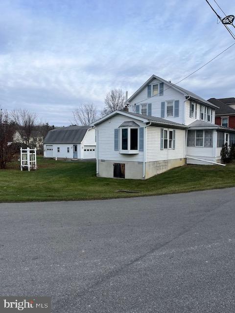 view of home's exterior with a lawn and a sunroom