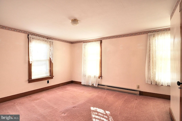 unfurnished room featuring baseboard heating and carpet floors