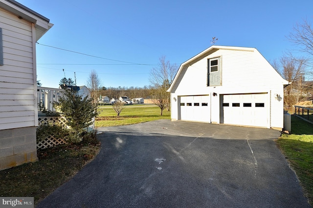 exterior space featuring a yard, an outdoor structure, and a garage