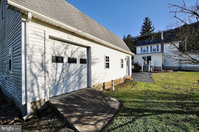 view of property exterior featuring a yard and a garage