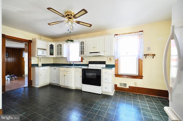 kitchen featuring white cabinets, white appliances, ceiling fan, and sink