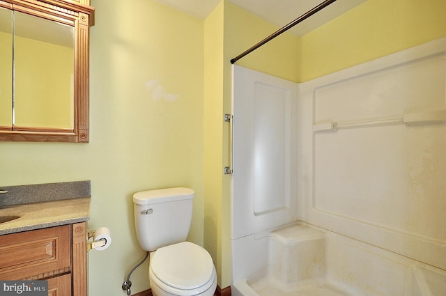 bathroom with vanity, toilet, and walk in shower