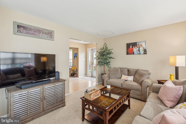 carpeted living room featuring french doors