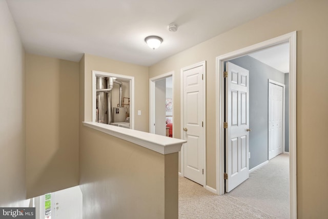 hall featuring light colored carpet