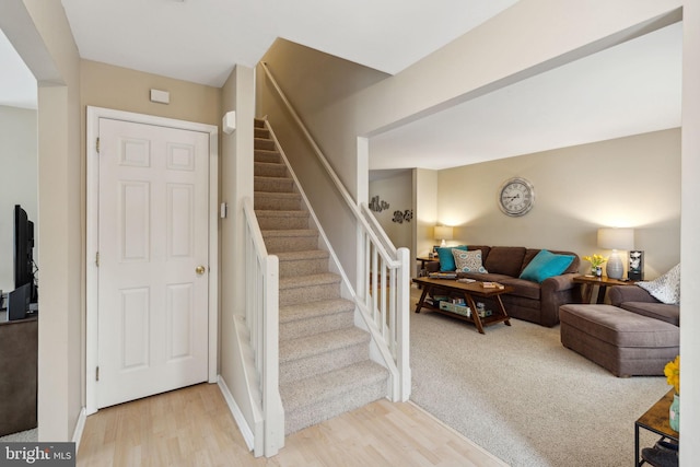 stairway with hardwood / wood-style floors