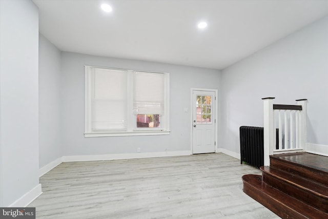 entryway featuring light wood-type flooring and radiator