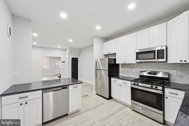 kitchen featuring white cabinetry, light hardwood / wood-style flooring, and stainless steel appliances