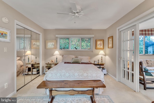 bedroom featuring light carpet, a closet, and ceiling fan