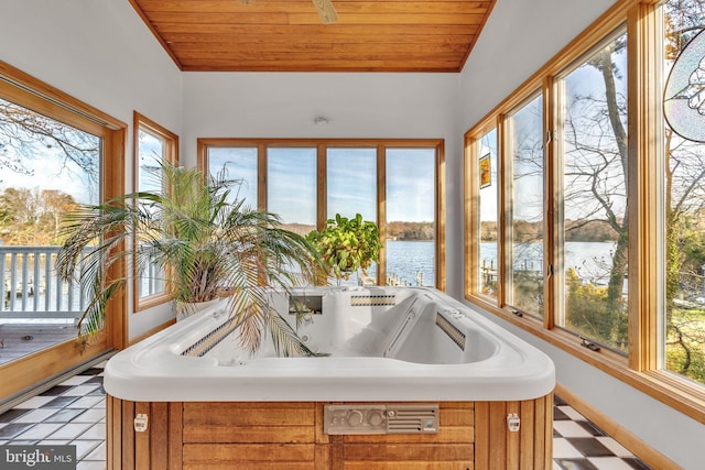 sunroom with a water view and wooden ceiling