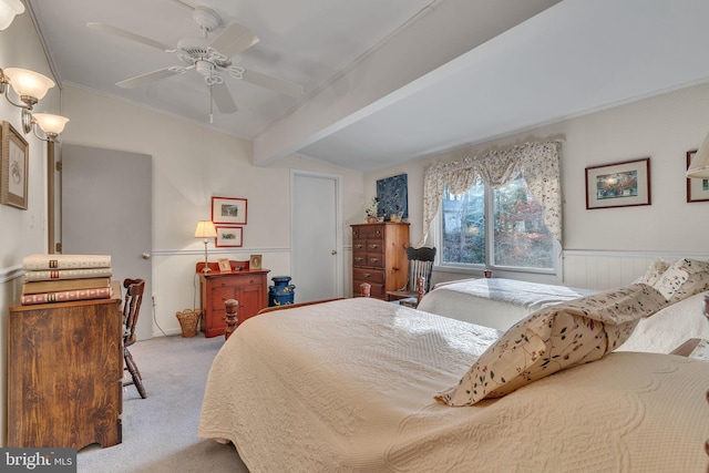 carpeted bedroom featuring ceiling fan, crown molding, and lofted ceiling with beams