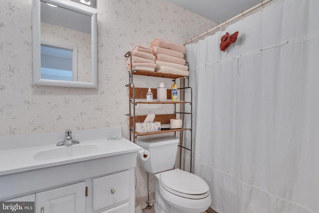 bathroom with vanity, toilet, and curtained shower