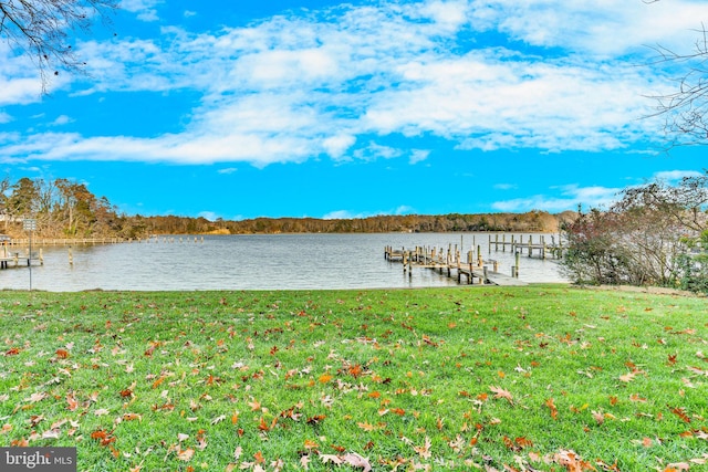 view of dock featuring a yard and a water view