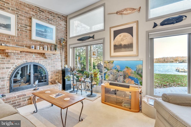 carpeted living room with a fireplace, brick wall, and a high ceiling