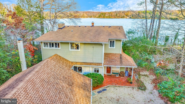 rear view of house featuring a water view