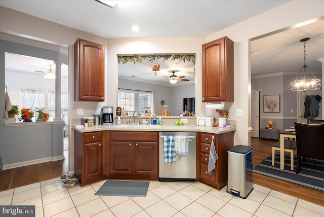 kitchen with sink, ceiling fan with notable chandelier, ornamental molding, decorative light fixtures, and stainless steel dishwasher