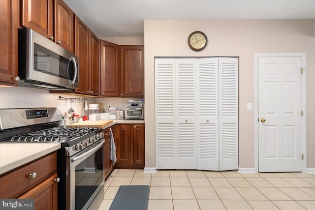 kitchen featuring light tile patterned floors and stainless steel appliances